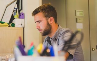 a business owner works on essential marketing tasks at his computer